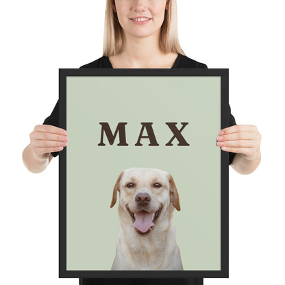 Woman holding a custom dog portrait in a black frame: Labrador on a sage background with the name MAX