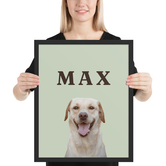 Woman holding a custom dog portrait in a black frame: Labrador on a sage background with the name MAX