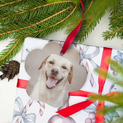 Personalized paw-shaped dog photo ornament with red ribbon on a wrapped Christmas gift
